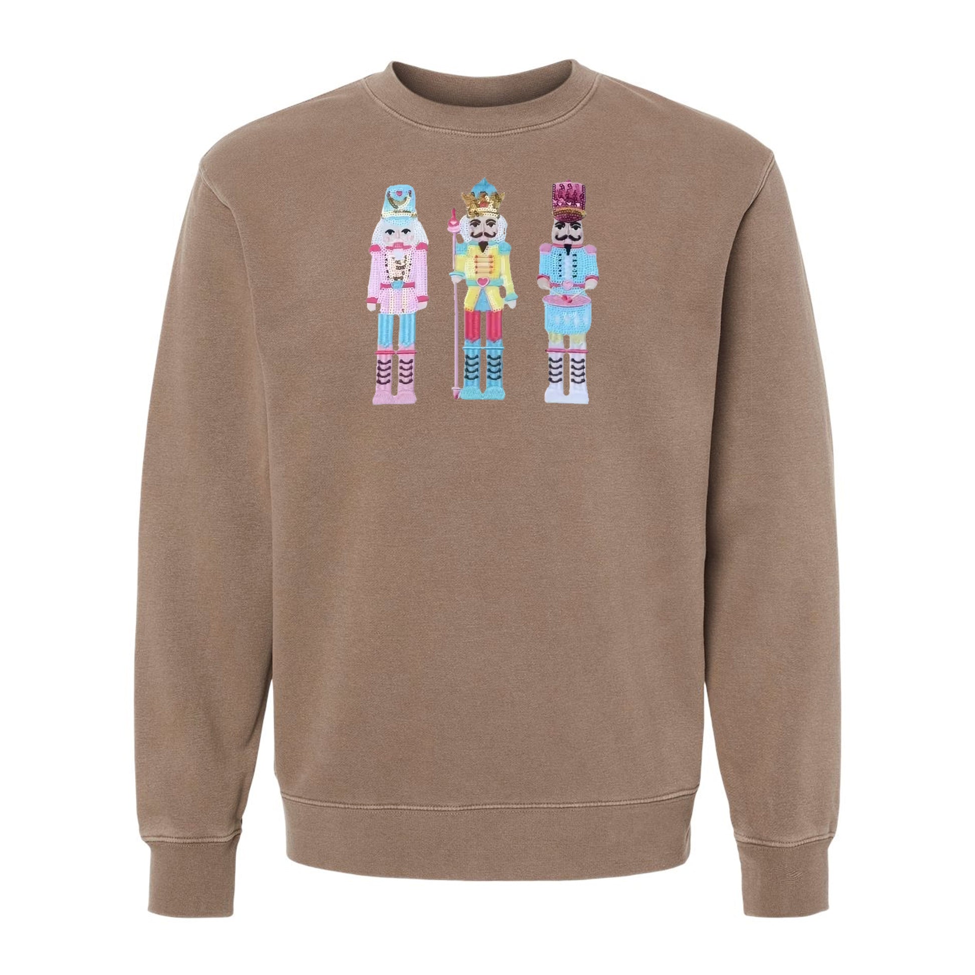 Flat lay of nutcracker appliqué pigment-dyed crewneck sweatshirt in beige